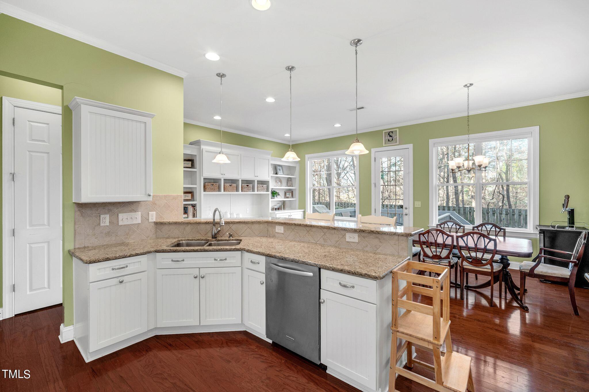 1104 Chapanoke Road Raleigh, NC 27603 - Photo 12 of 31 a kitchen with a sink window and chairs