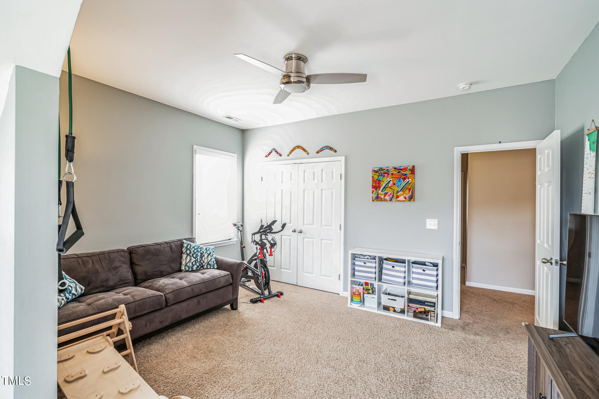 1104 Chapanoke Road Raleigh, NC 27603 - Photo 27 of 31 a living room with furniture and a flat screen tv