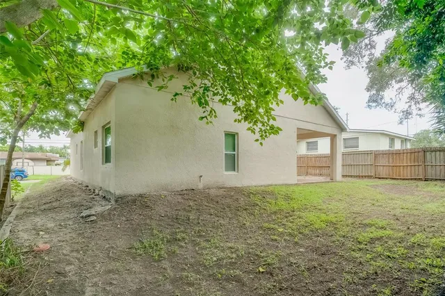 a view of a house with a wooden fence