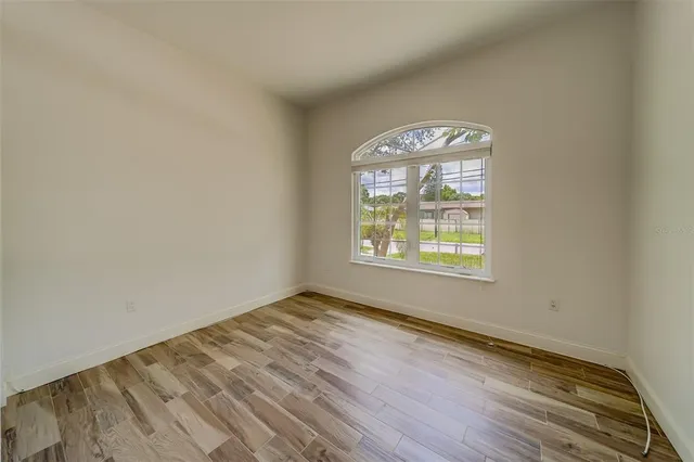 wooden floor in an empty room with a window