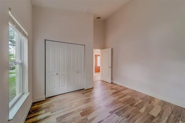 a view of a living room and a kitchen with wooden floor