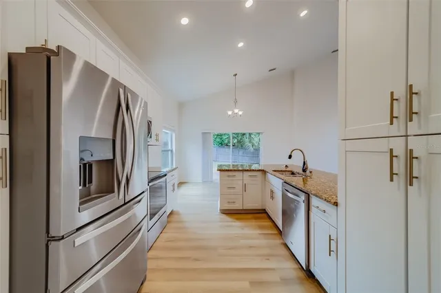 a kitchen with stainless steel appliances and white cabinets