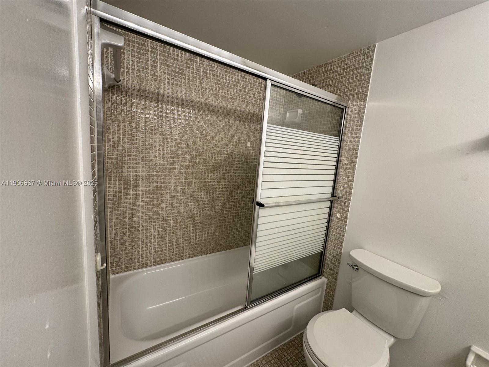 5800 Southwest 127th Avenue, Unit 2307 Miami, FL 33183 - Photo 14 of 23 a bathroom with a toilet and a shower