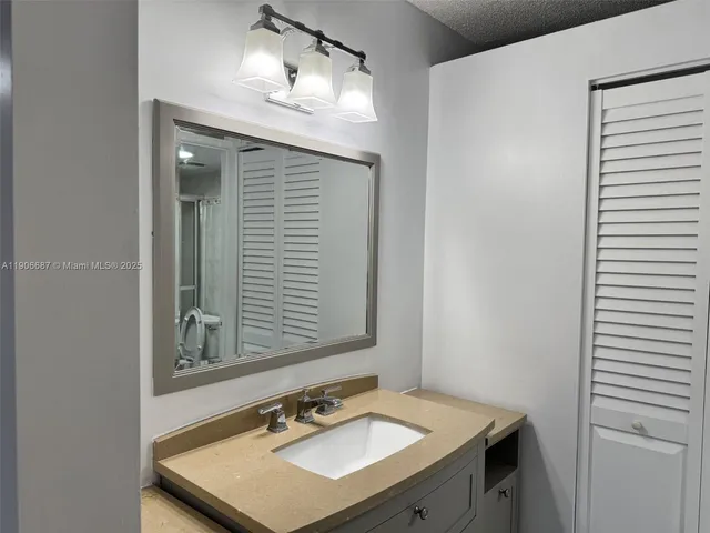 a bathroom with a sink vanity and a mirror