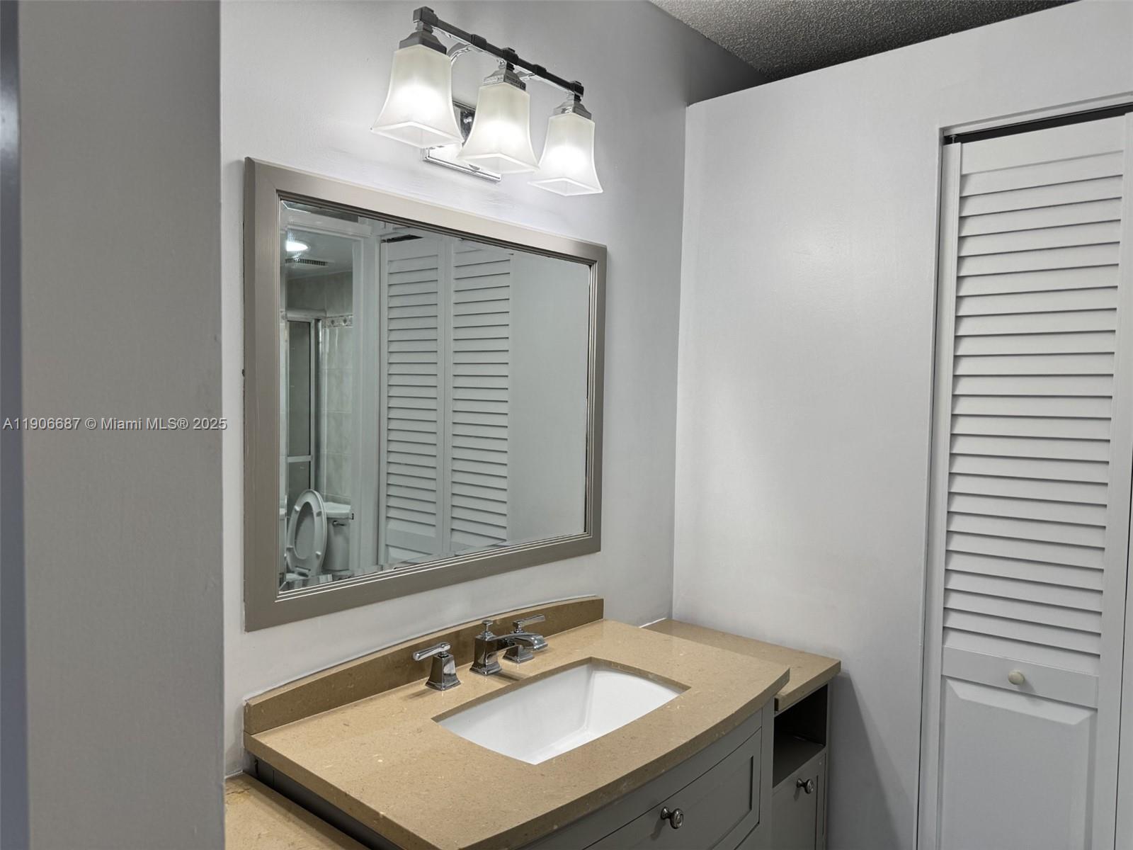 5800 Southwest 127th Avenue, Unit 2307 Miami, FL 33183 - Photo 15 of 23 a bathroom with a sink vanity and a mirror
