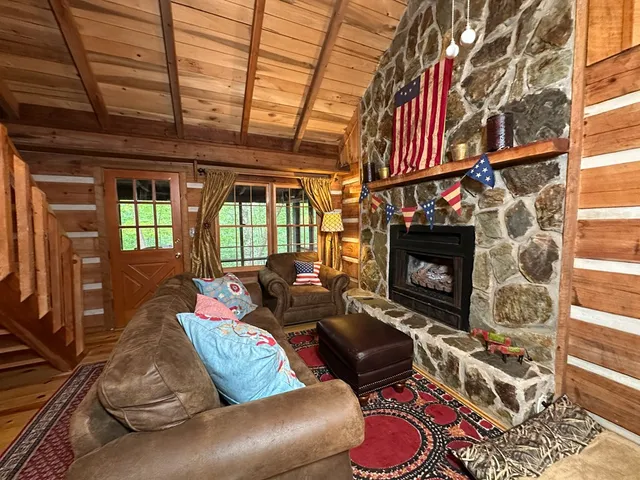 a living room with furniture a rug and a fireplace