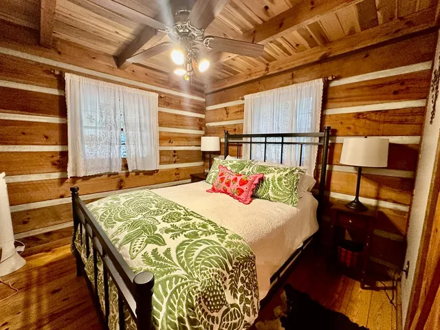 a bed sitting in a bedroom next to a window