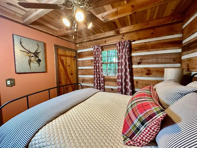 a bedroom with a bed and a chandelier