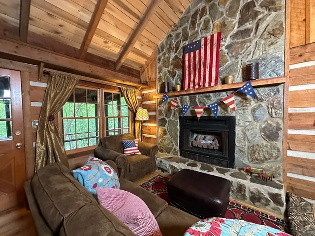 a living room with furniture a fireplace and a window