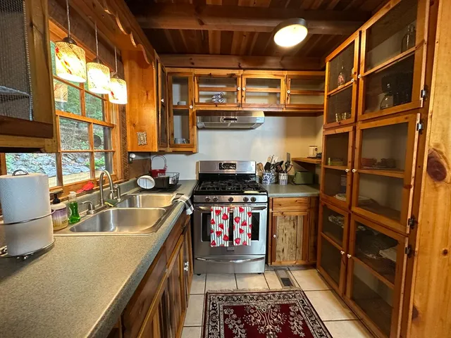 a kitchen with stainless steel appliances granite countertop a stove and a sink