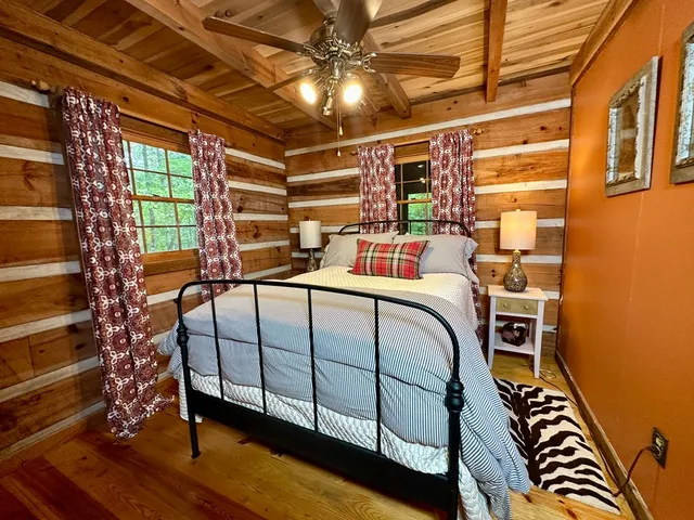 a bedroom with furniture and a window