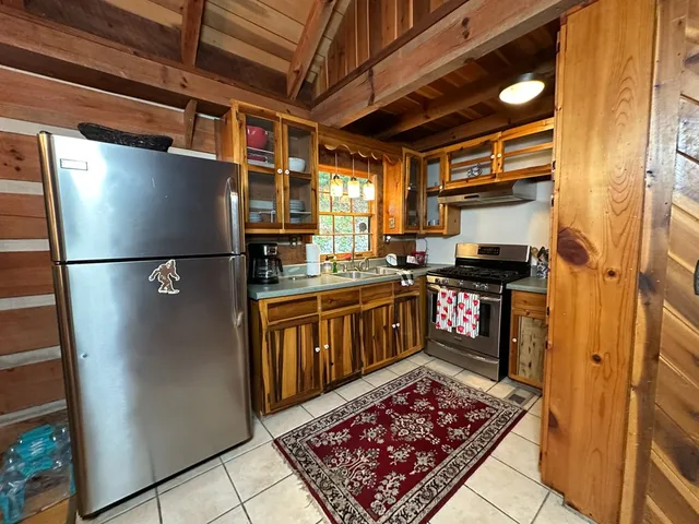 a kitchen with stainless steel appliances granite countertop a refrigerator stove and sink