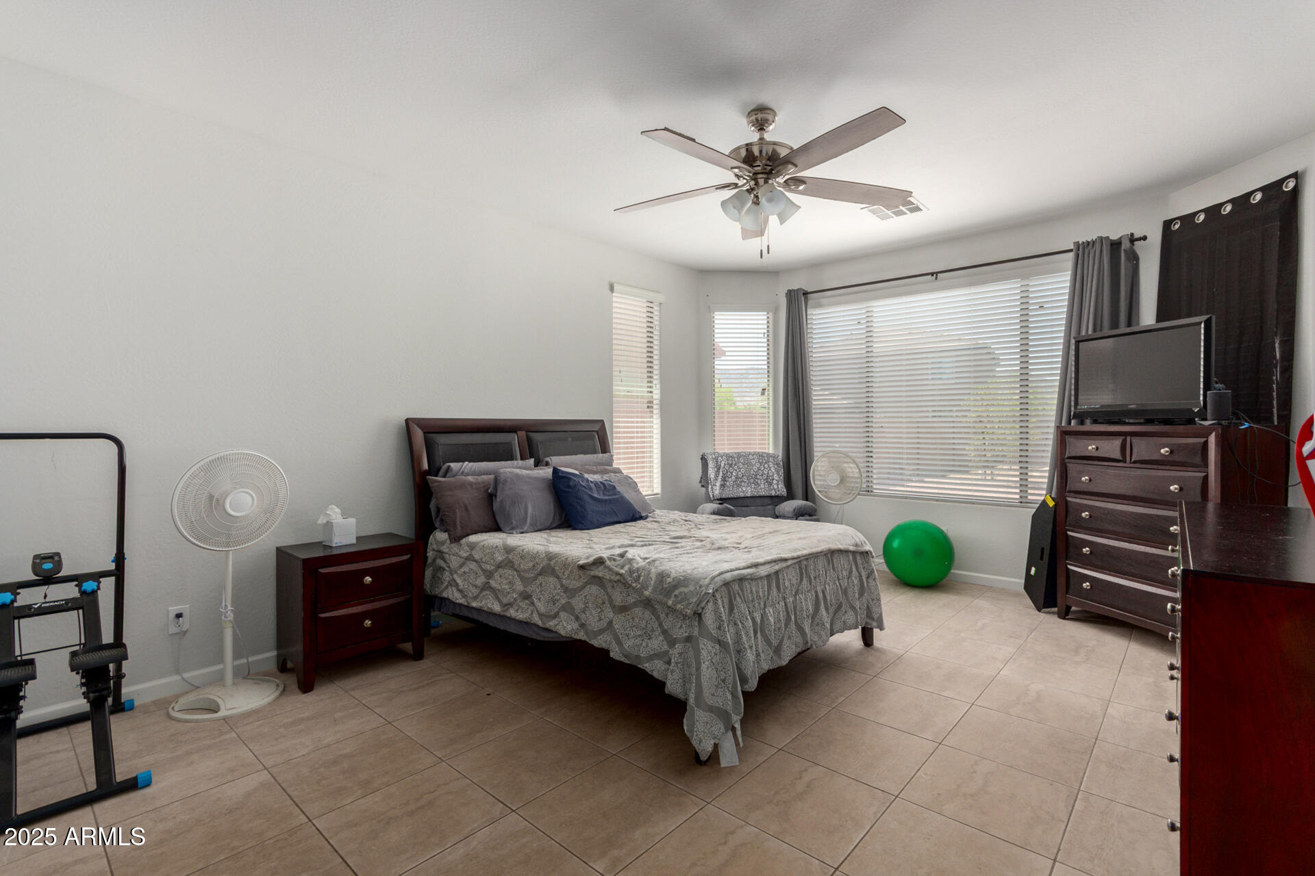 2413 West Beverly Rd. Phoenix, AZ 85041 - Photo 14 of 28 a bedroom with a bed a chandelier and a flat screen tv