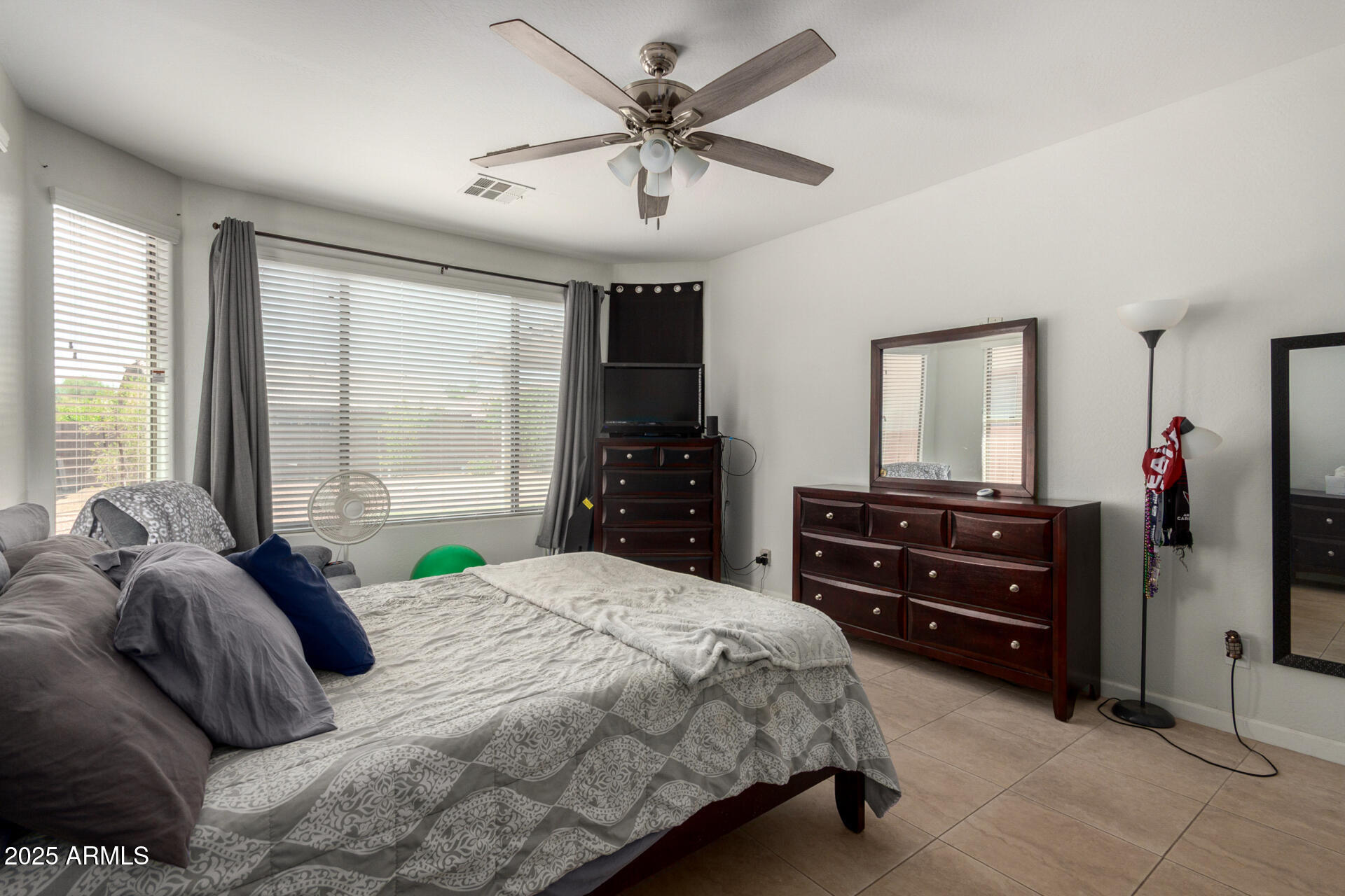 2413 West Beverly Rd. Phoenix, AZ 85041 - Photo 16 of 28 a bedroom with a bed and a mirror on dresser