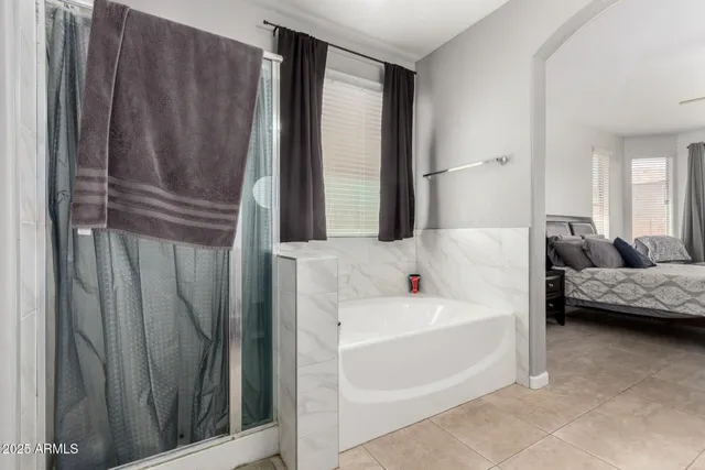 a bathroom with a tub and a shower