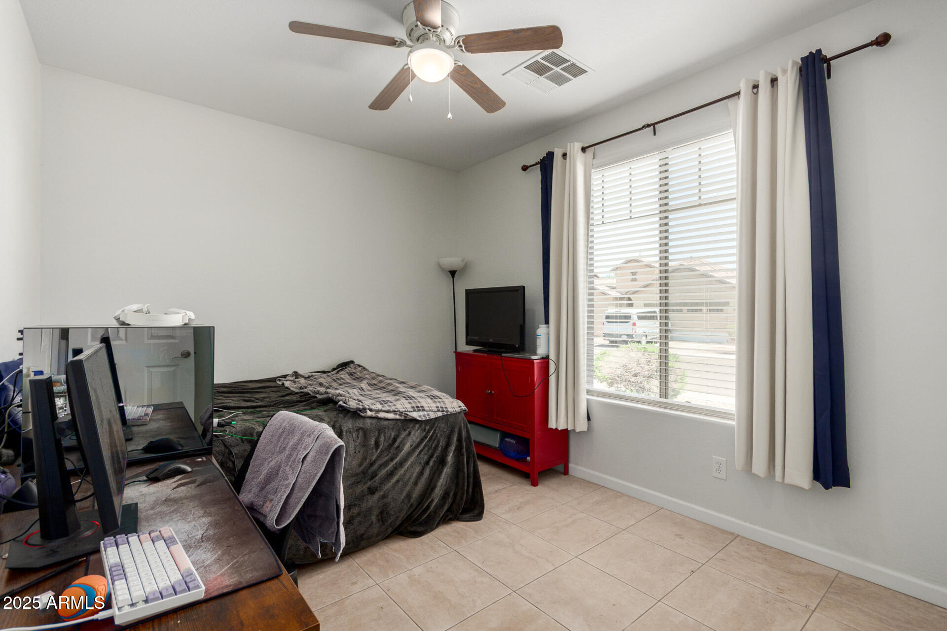 2413 West Beverly Rd. Phoenix, AZ 85041 - Photo 19 of 28 a bed room with a bed and a window