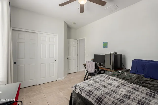 a bed room with a bed and a chair