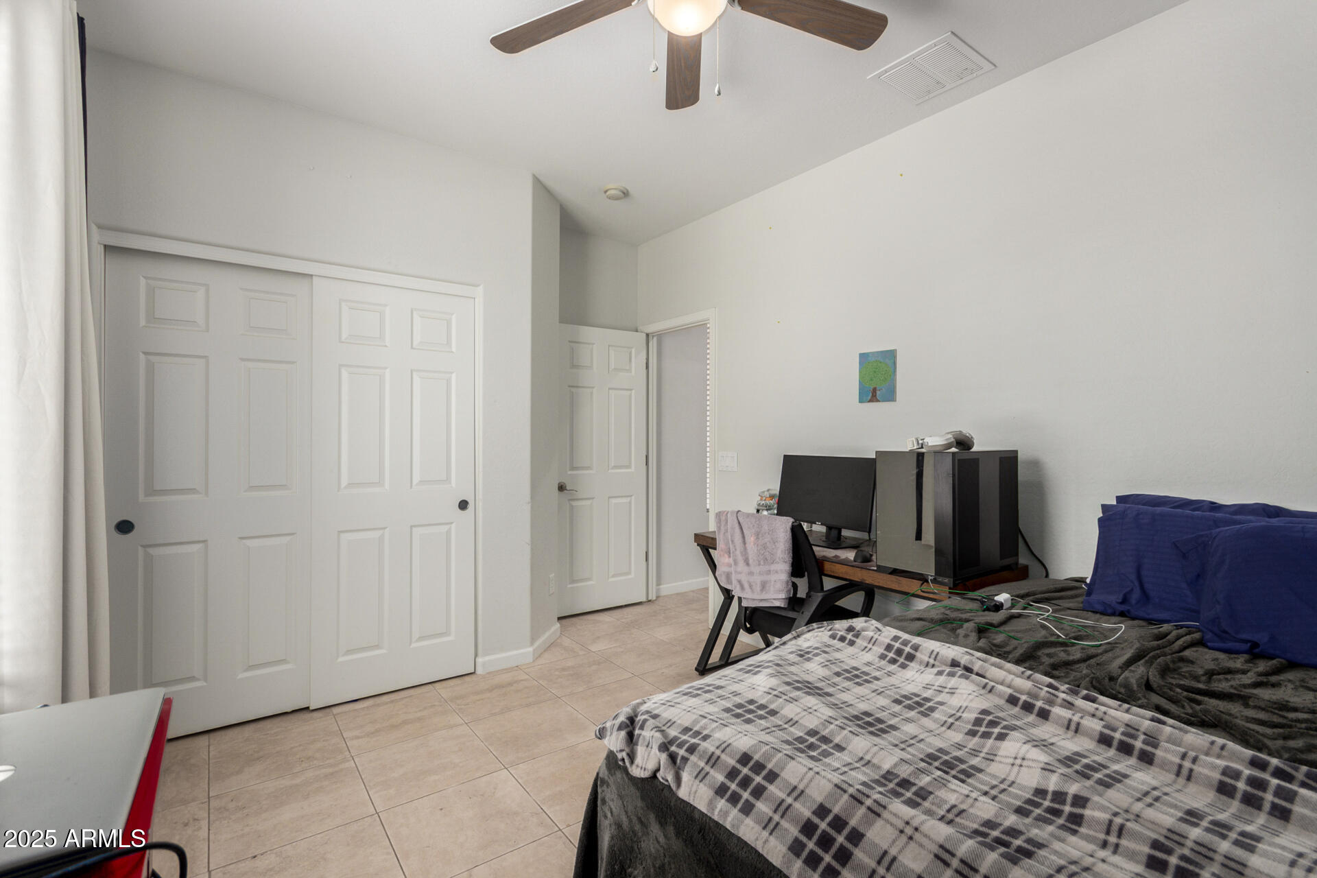 2413 West Beverly Rd. Phoenix, AZ 85041 - Photo 20 of 28 a bed room with a bed and a chair