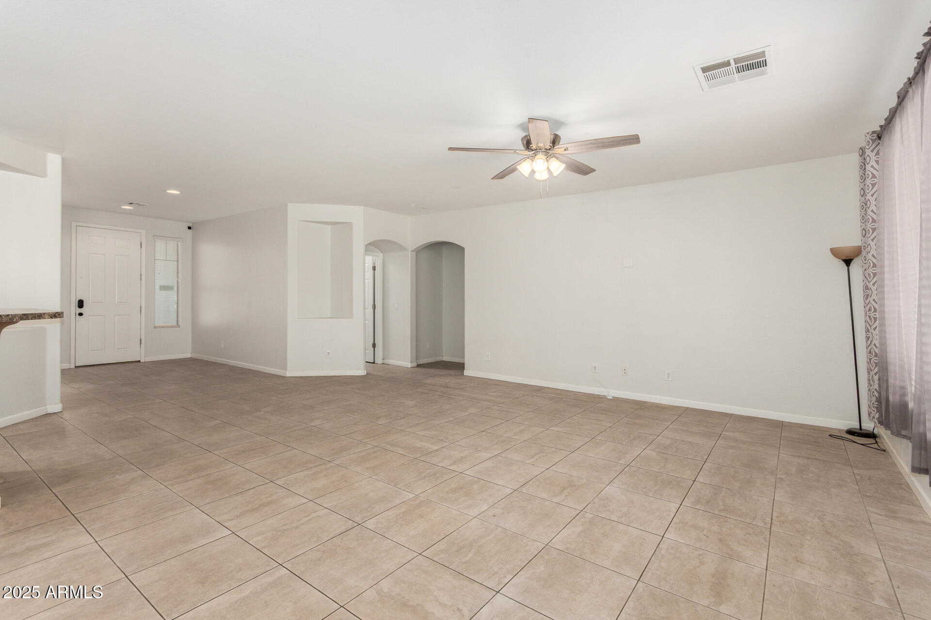 2413 West Beverly Rd. Phoenix, AZ 85041 - Photo 7 of 28 wooden floor in an empty room with a window