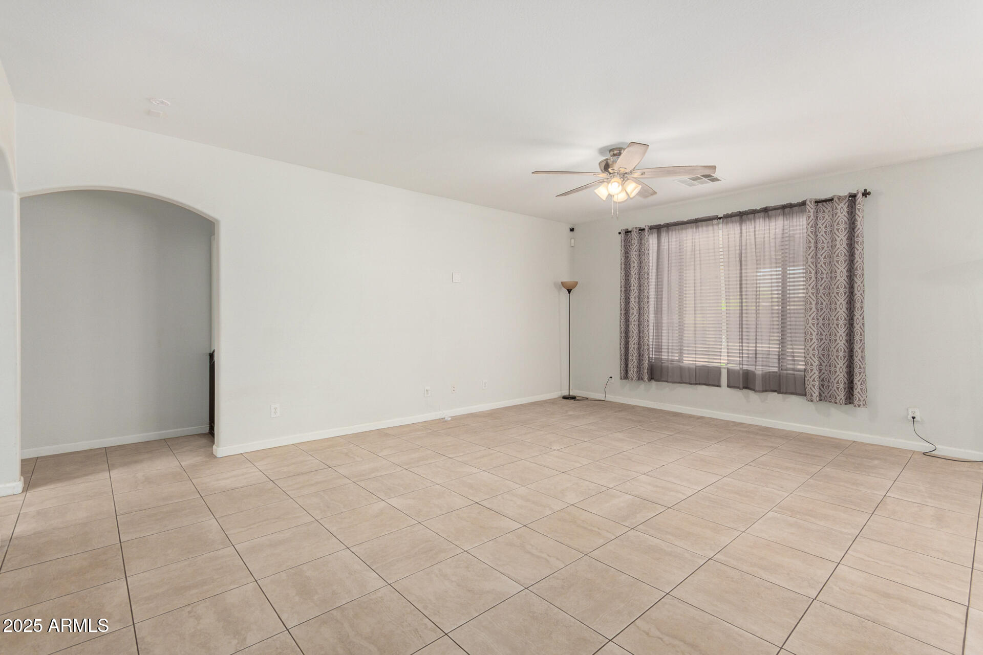 2413 West Beverly Rd. Phoenix, AZ 85041 - Photo 8 of 28 a view of an empty room with a window