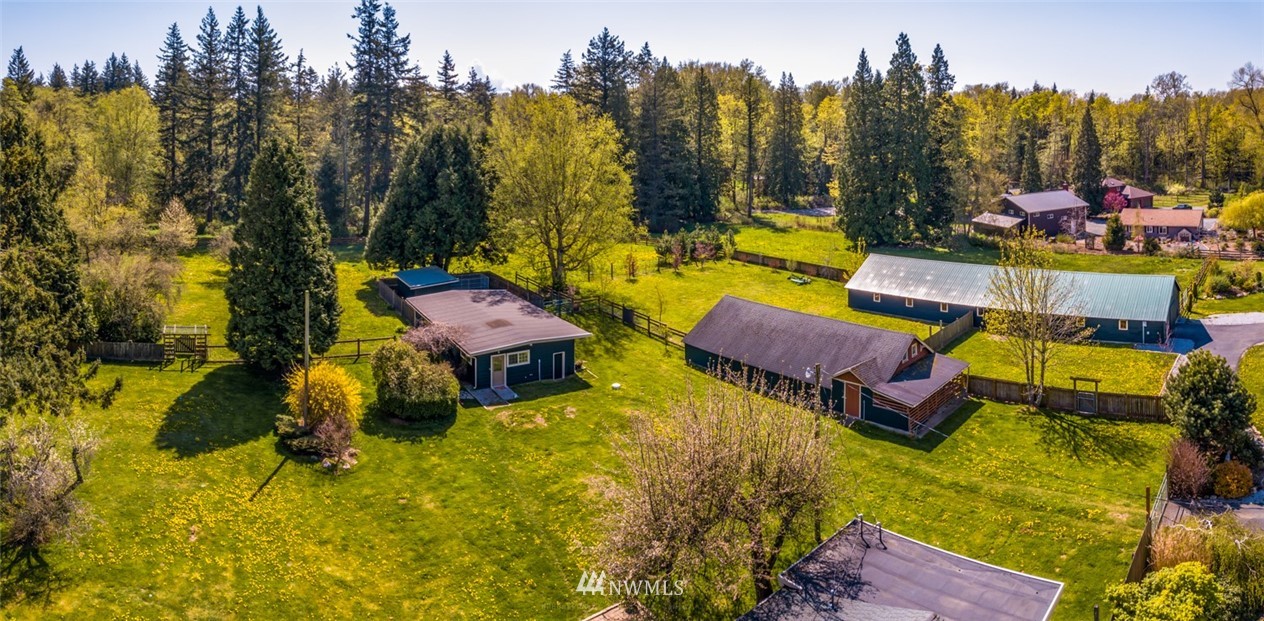 3879 Brown Road Ferndale, WA 98248 - Photo 22 of 36 a view of swimming pool with outdoor seating and trees in the background