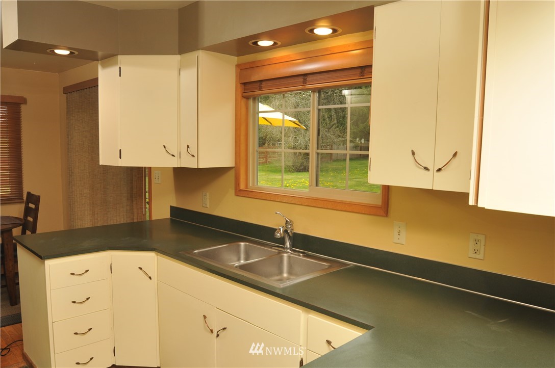 3879 Brown Road Ferndale, WA 98248 - Photo 9 of 36 a kitchen with white cabinets and a sink