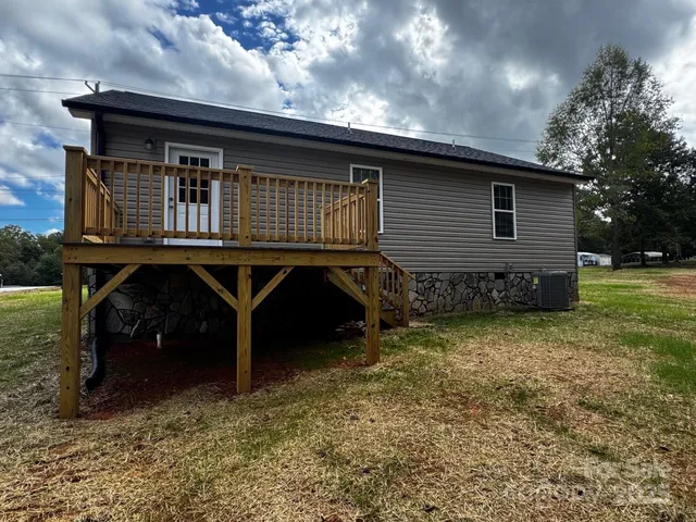 a backyard of a house with barbeque oven table and chairs