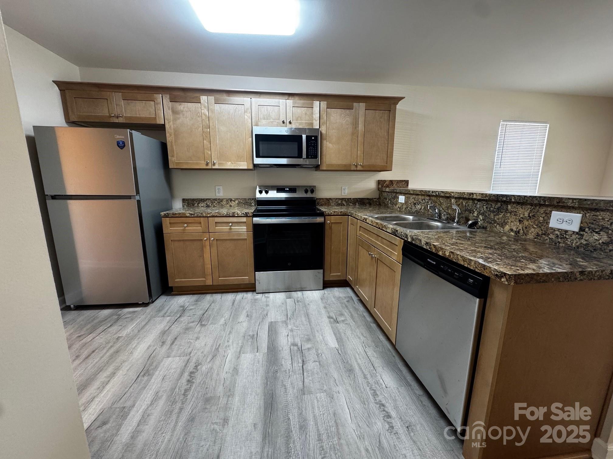 194 Providence Mill Road Maiden, NC 28650 - Photo 2 of 15 a kitchen with granite countertop a refrigerator stove top oven and sink