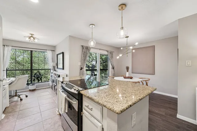 a kitchen with granite countertop living room and living room