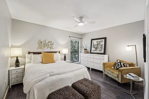 a bedroom with a bed and wooden floor