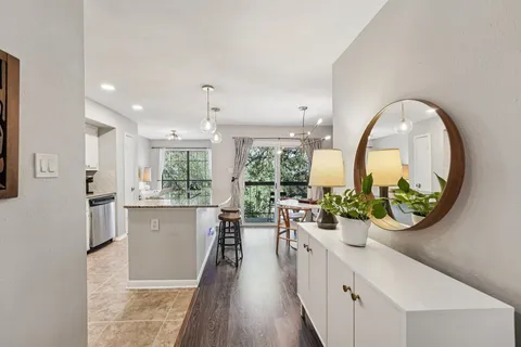 a kitchen with stainless steel appliances granite countertop counter space a sink refrigerator and cabinets