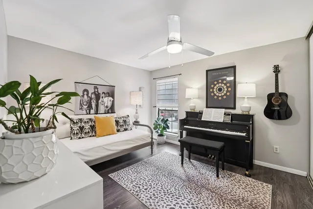 a living room with furniture a chandelier and a rug