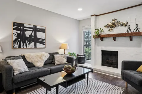 a living room with furniture a couch and a fireplace