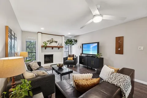 a living room with furniture and a fireplace