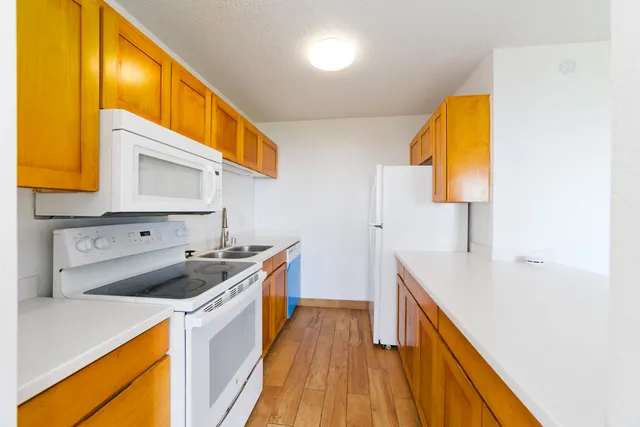 a kitchen with a sink and wooden cabinets