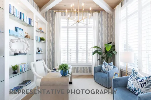 a living room with furniture and a chandelier