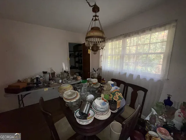 a very nice looking dining room with furniture window and outside view