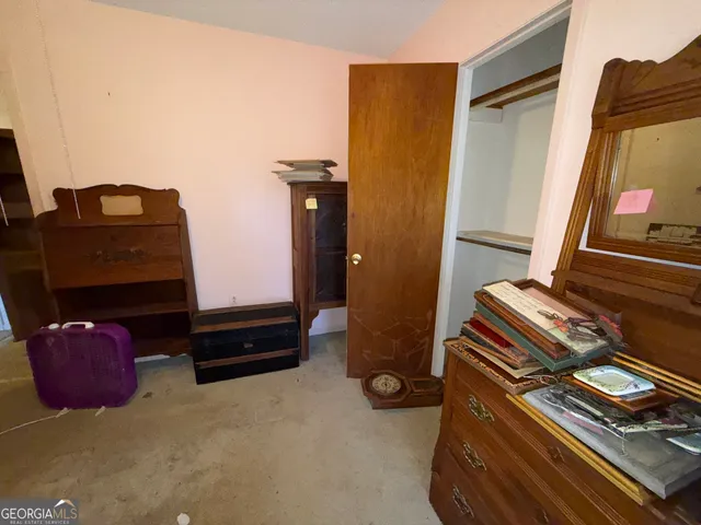 a bedroom with a bed and a mirror