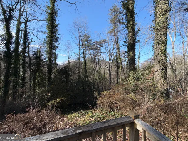 a view of a wooden fence and trees
