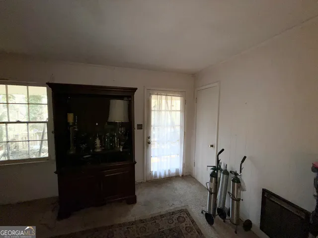 a view of a room that has a bed and a window