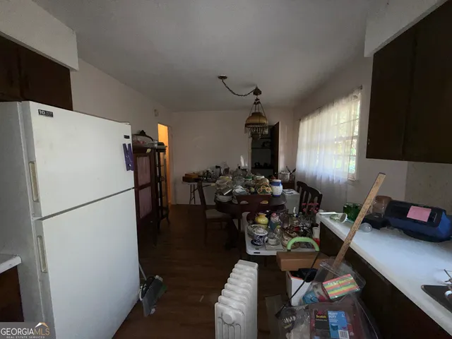 a kitchen with sink refrigerator and dining table