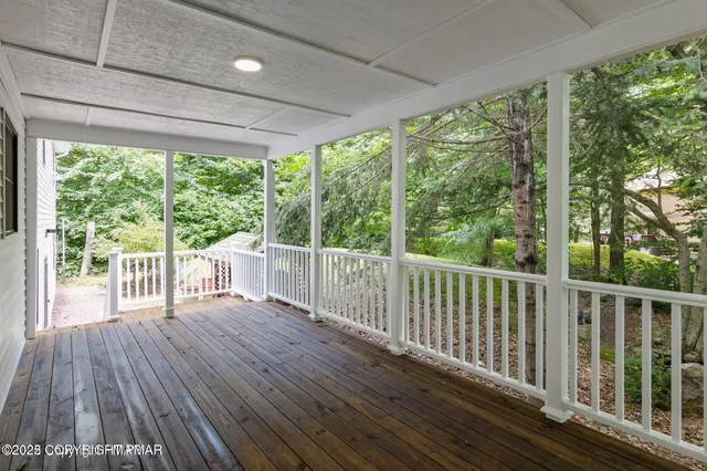 a view of a wooden deck with a yard