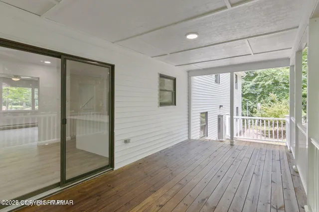 a view of a porch with wooden floor and a balcony