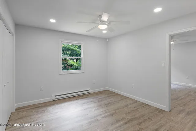 wooden floor in an empty room with a window