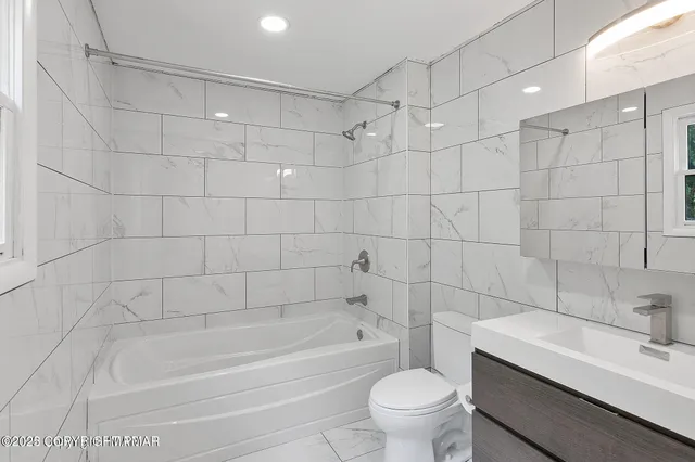 a bathroom with a bathtub toilet and sink