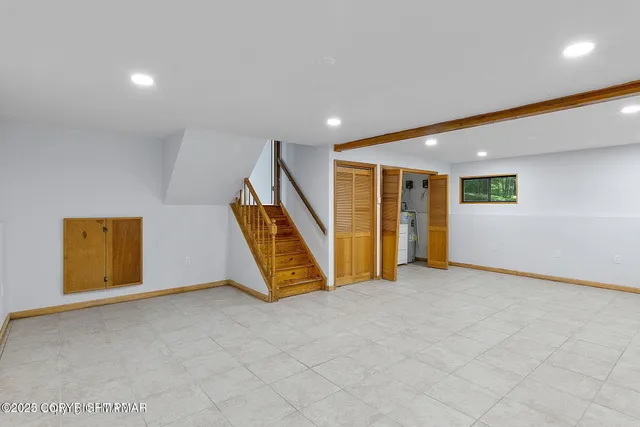 a view of an empty room with stairs