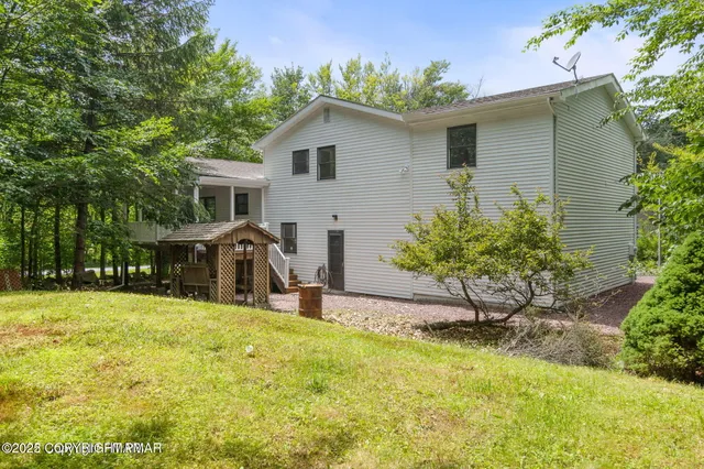 a front view of house with yard outdoor seating and barbeque oven