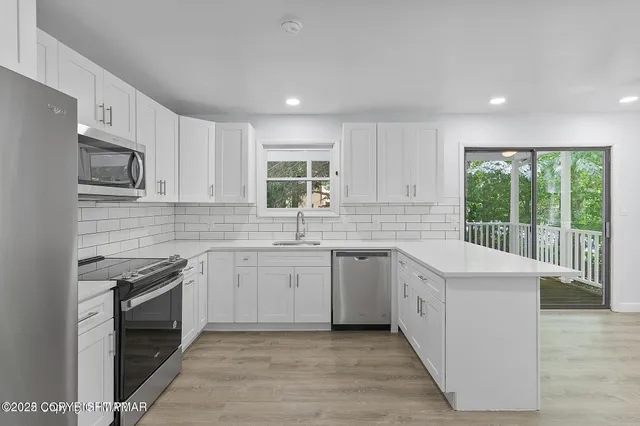 a kitchen with a sink stove top oven and cabinets