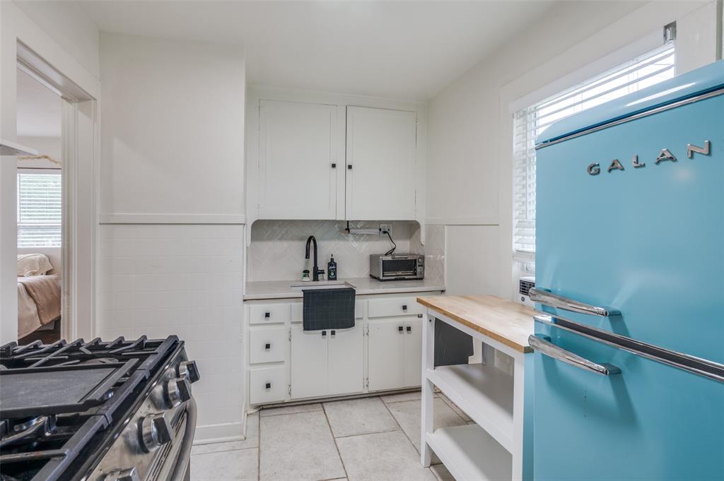 4601 Pershing Avenue Fort Worth, TX 76107 - Photo 23 of 28 a kitchen with a stove oven and white cabinets