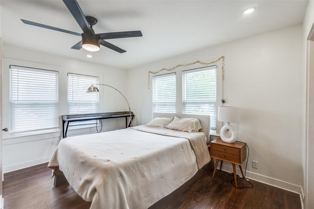 4601 Pershing Avenue Fort Worth, TX 76107 - Photo 25 of 28 a bedroom with a bed and a chair with the wooden floor